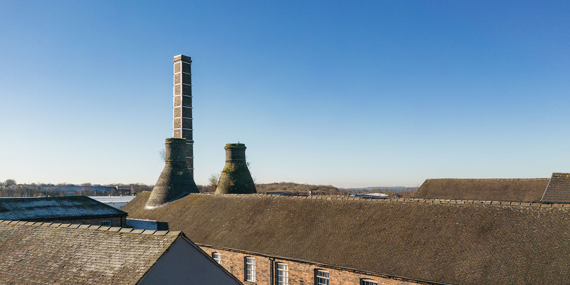 A brick building with a chimney in the background